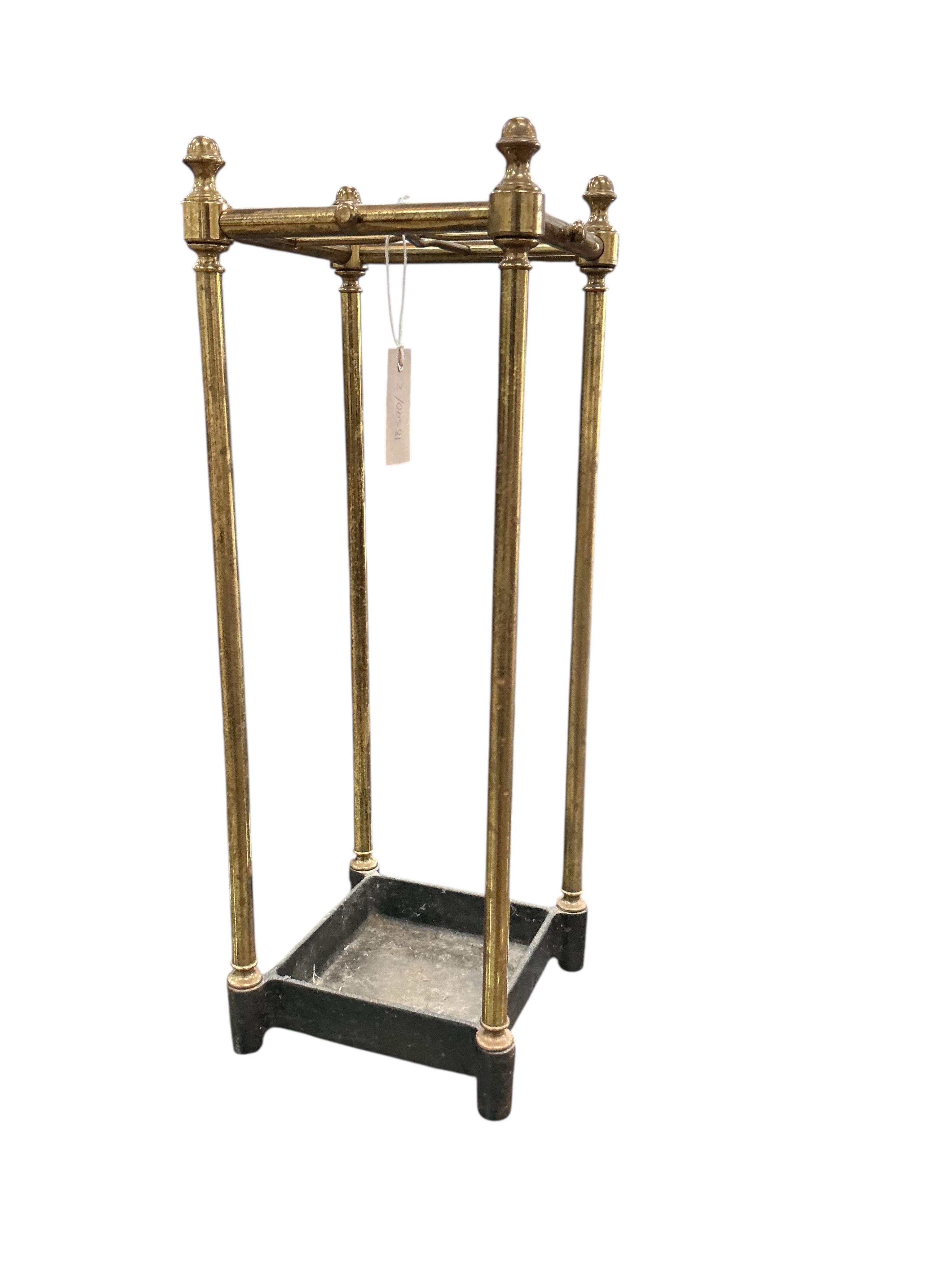 A brass and cast iron four division stick stand, width 21cm, height 59cm